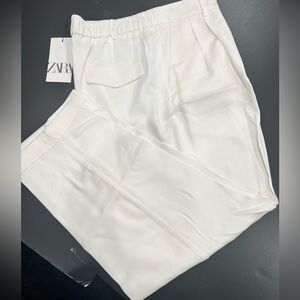 Women’s pleated white pants.